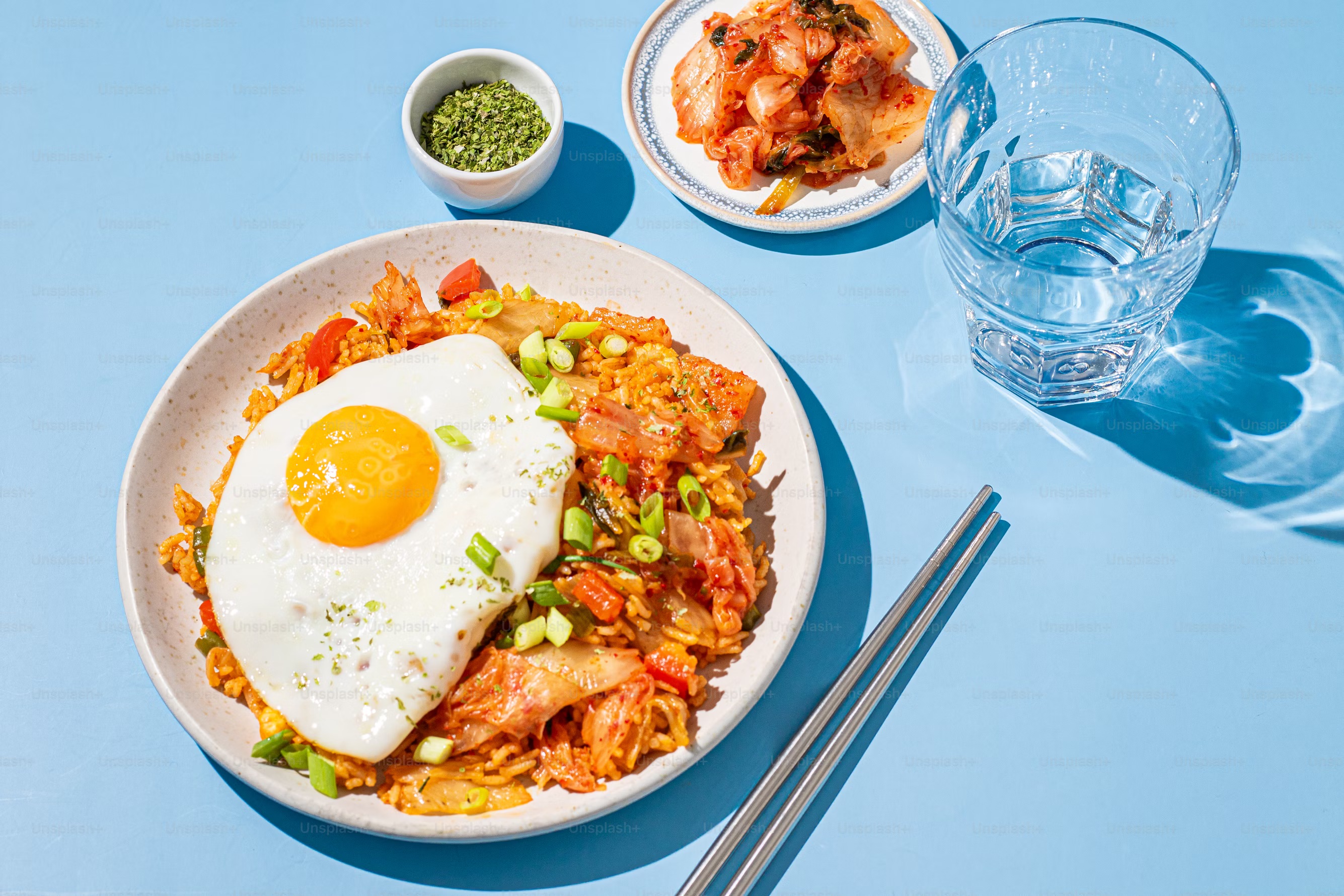 kimchi with eggs and ramen in red ceramic bowl